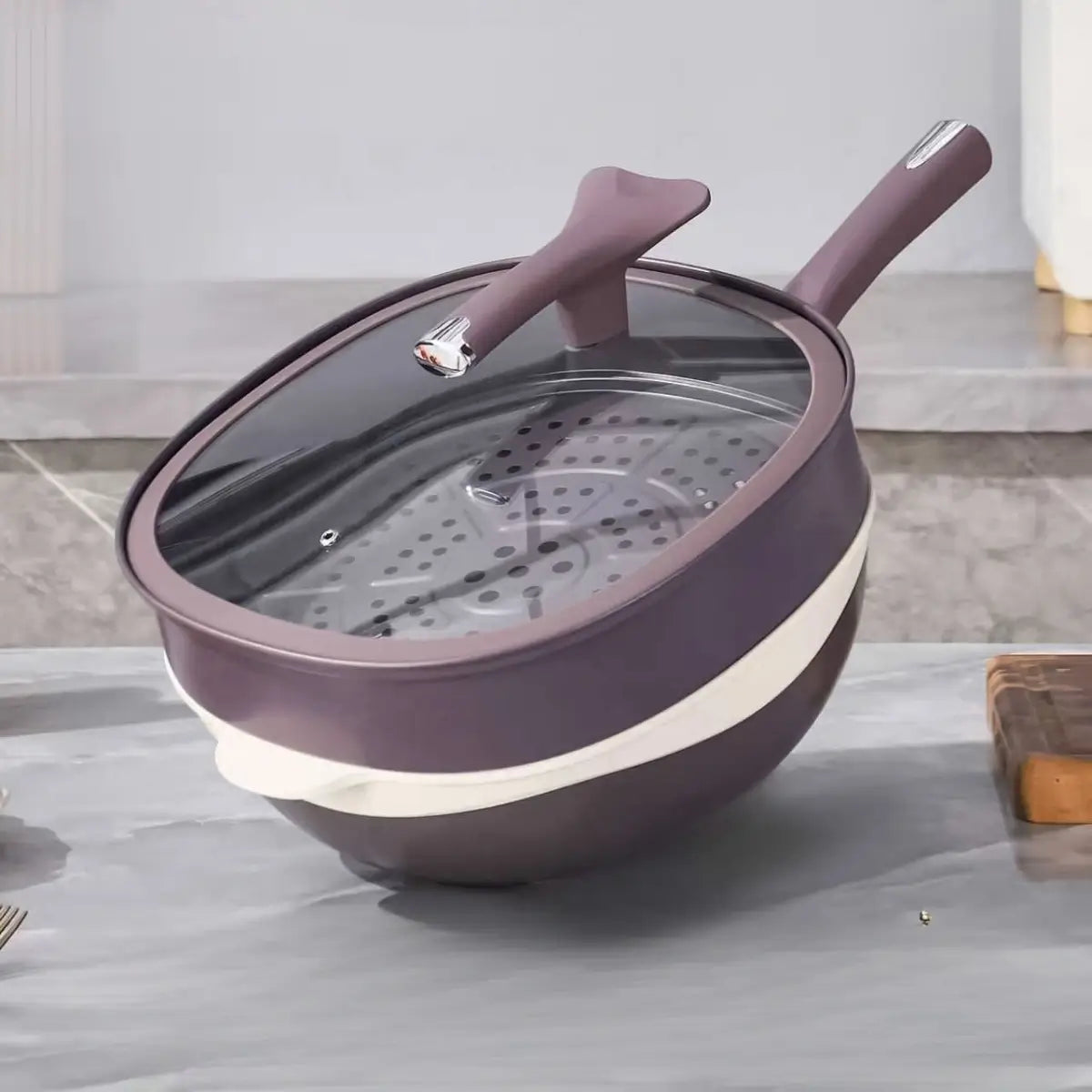 Matching glass lid and steamer stacked over the purple pan