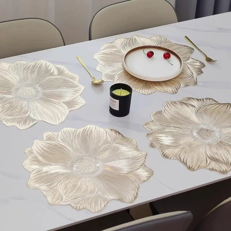 Gold lotus flower placemats arranged across a dining table