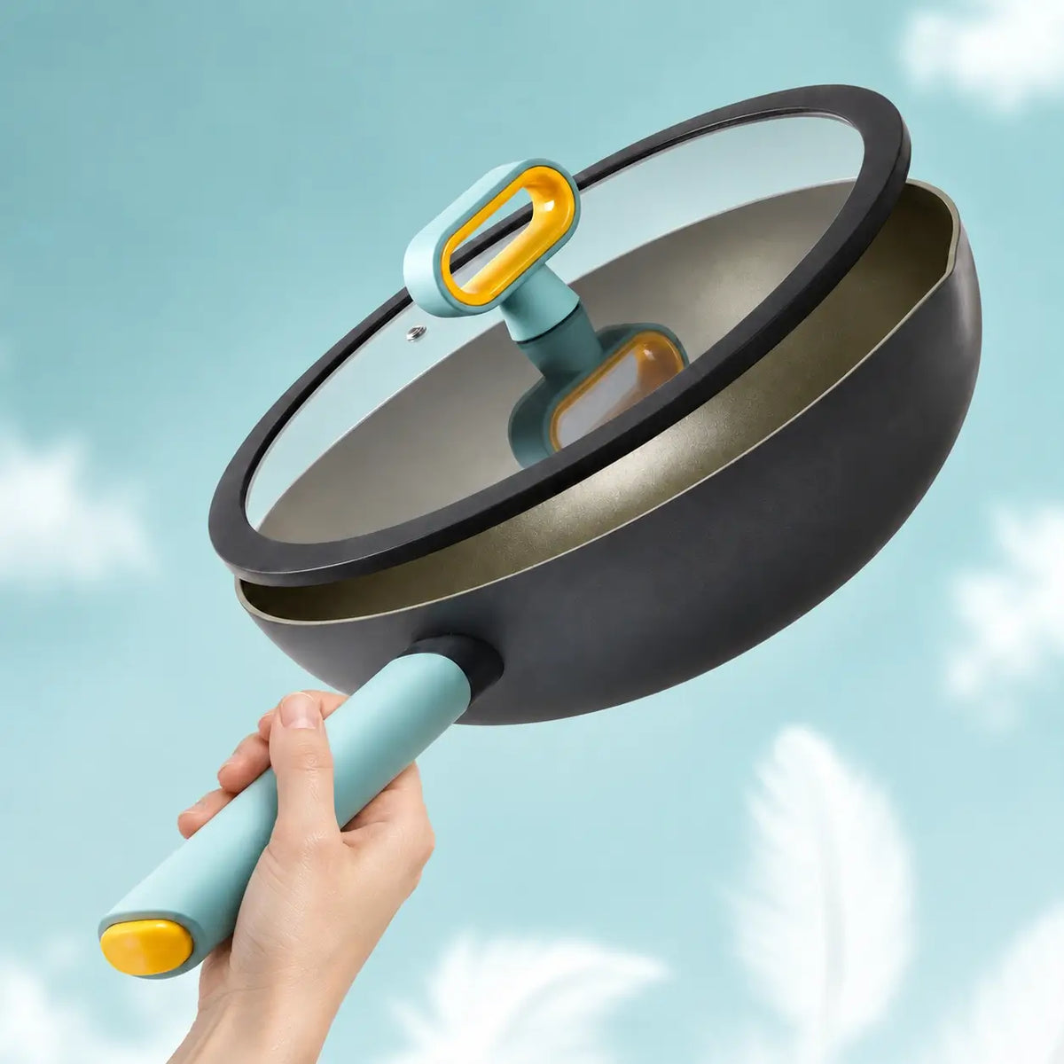 Hand lifting the lightweight pan with its glass lid