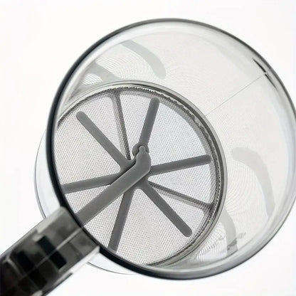 Close-up of a glass with a metal strainer on a white background