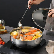 Extra-deep stainless steel bowl warming soup on an induction cooktop
