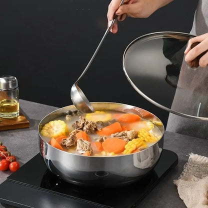 Extra-deep stainless steel bowl warming soup on an induction cooktop