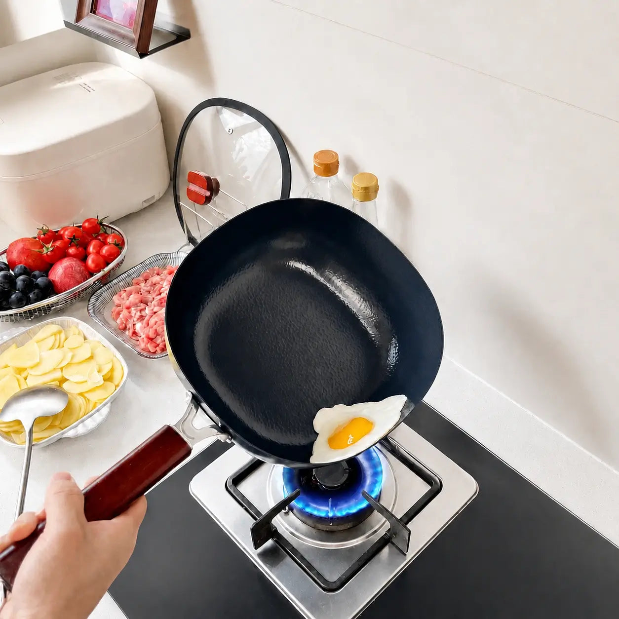 Egg cooking in the hammered pan over a gas flame