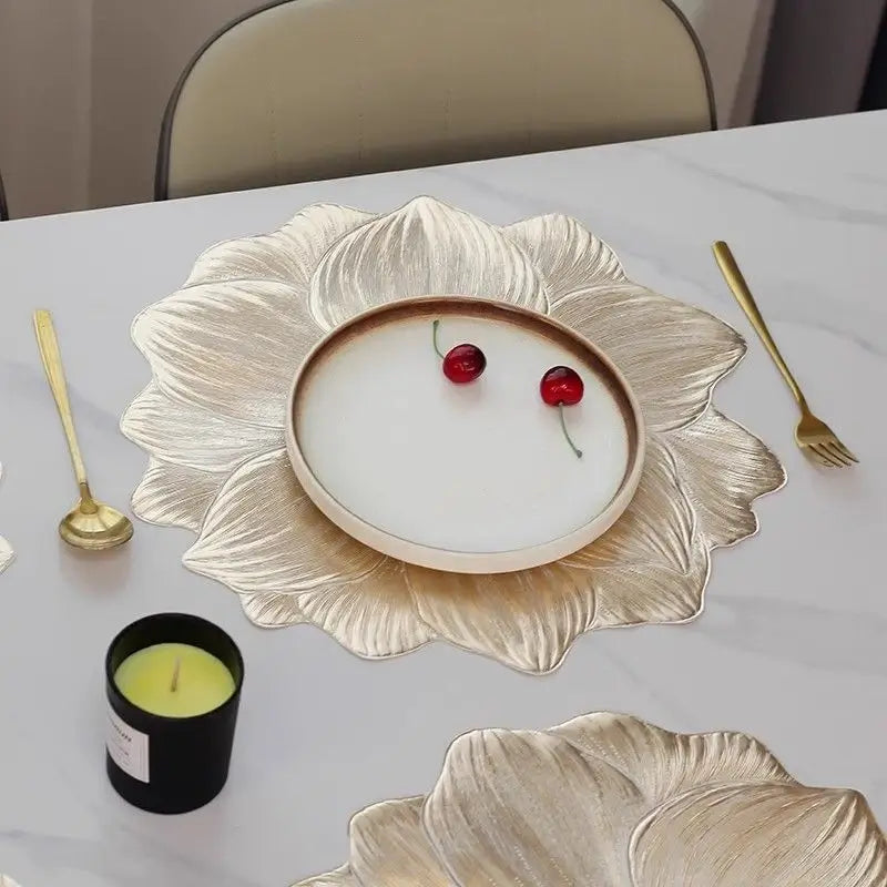 Gold lotus flower placemat framing a dinner plate on a dining table