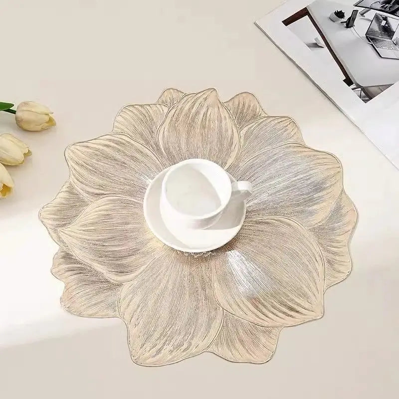 Gold lotus flower placemat under a white cup and saucer