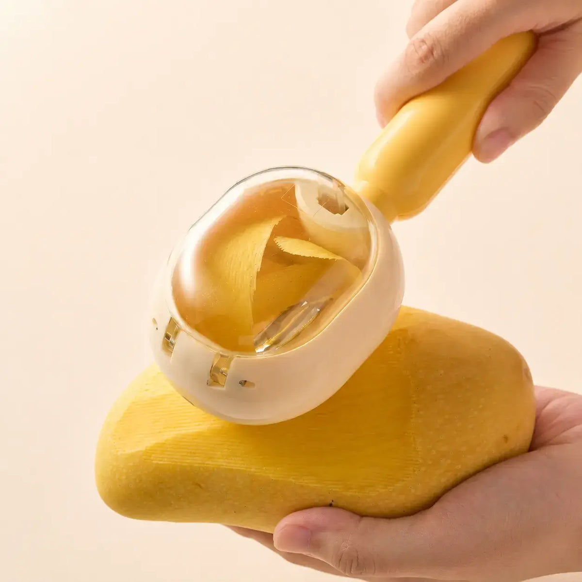 Yellow PeelCatch collecting potato peels around the blade