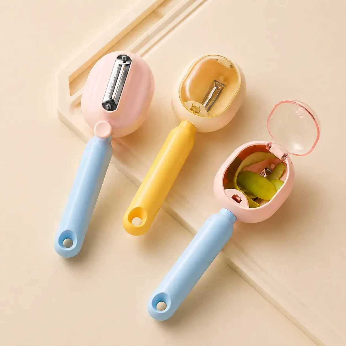 Pink and yellow PeelCatch peelers showing blade and collection chamber