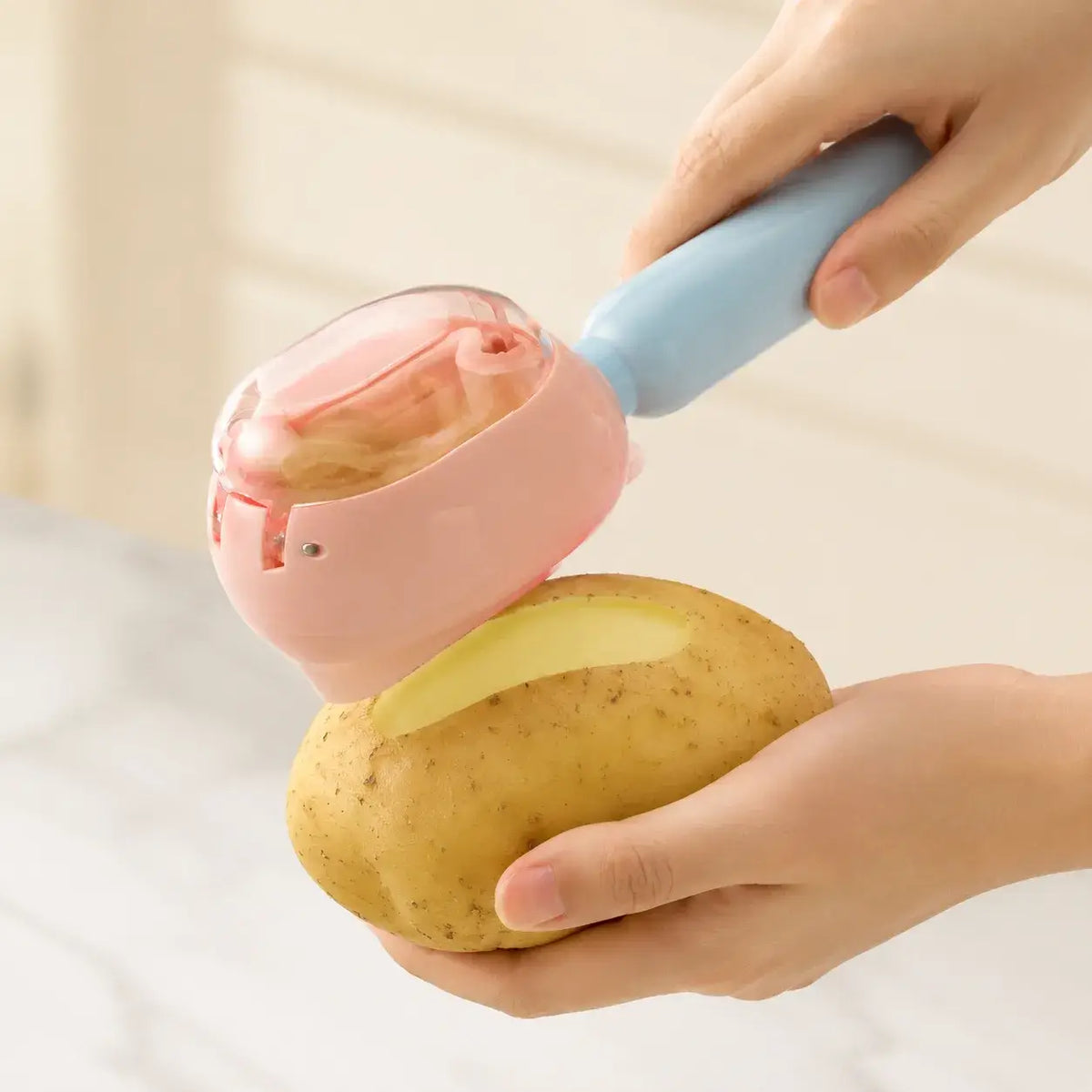 Pink PeelCatch peeling a potato and collecting peels