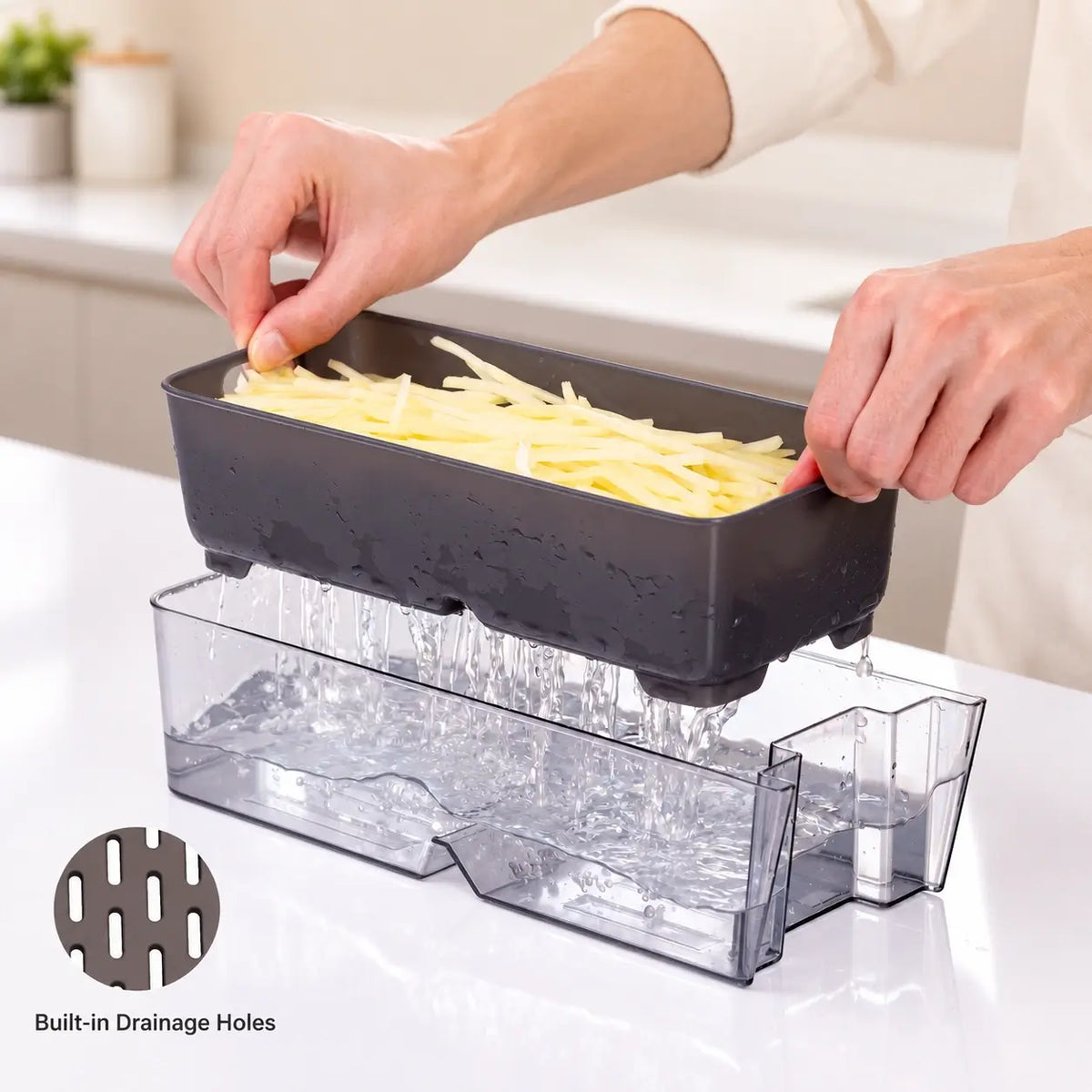 Removable basket draining cut potatoes above the clear collection container