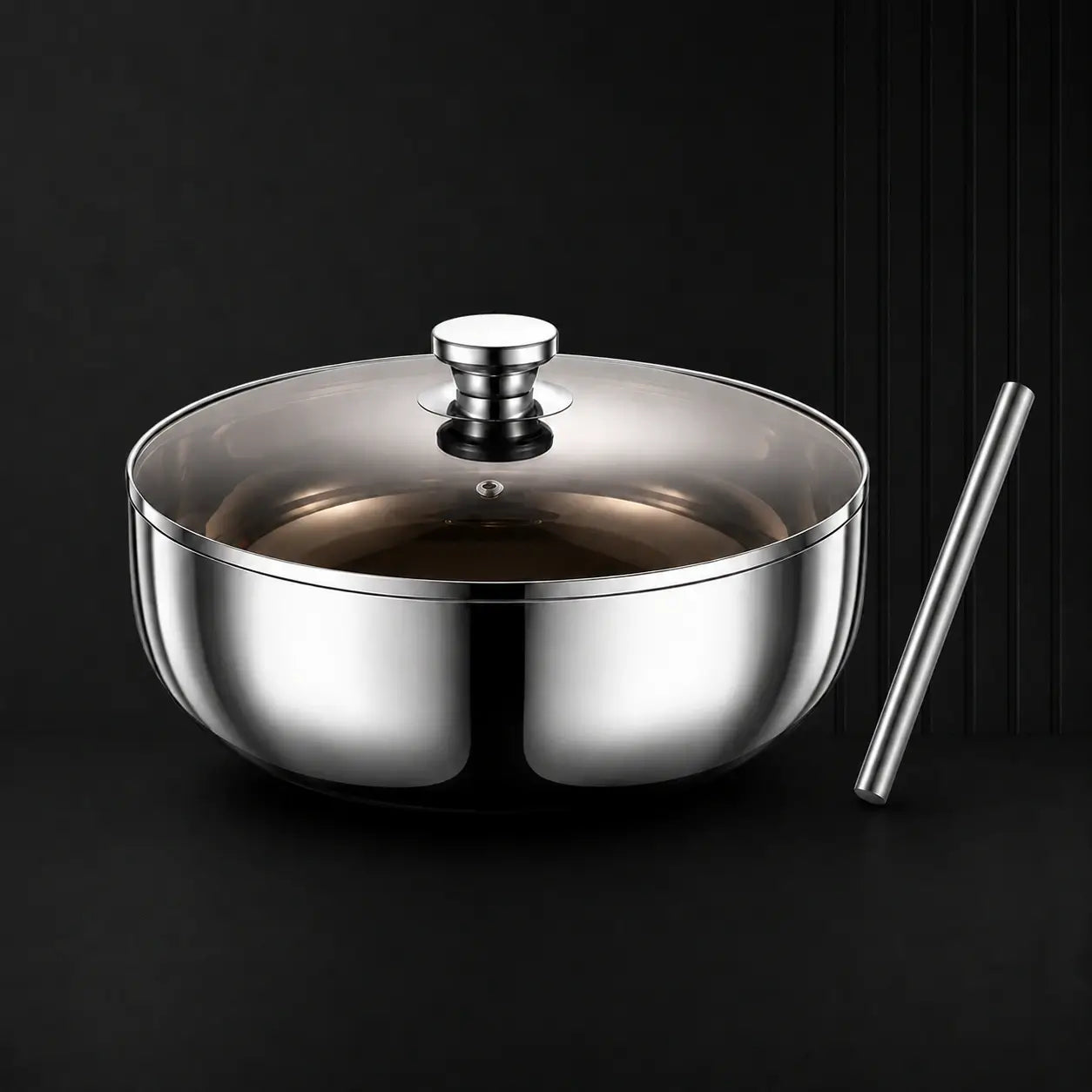 Stainless steel mixing bowl with glass lid and rolling pin on a dark background