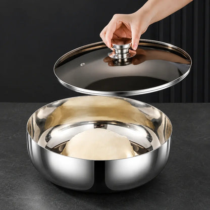 Hand placing a smoky glass lid over dough in a stainless steel bowl