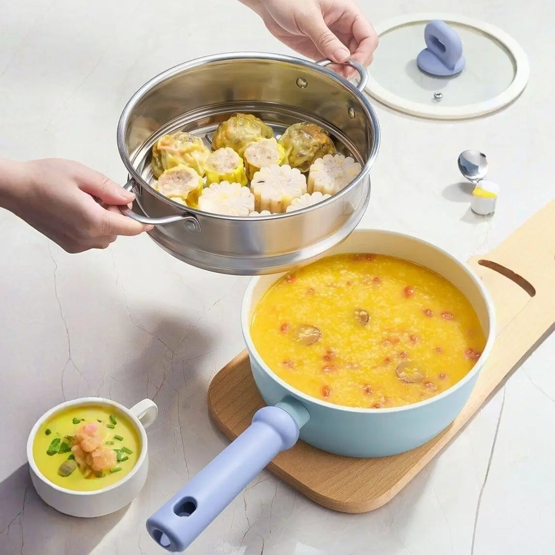 Stainless-steel steamer lifted above the Little Blue Ceramic Pot