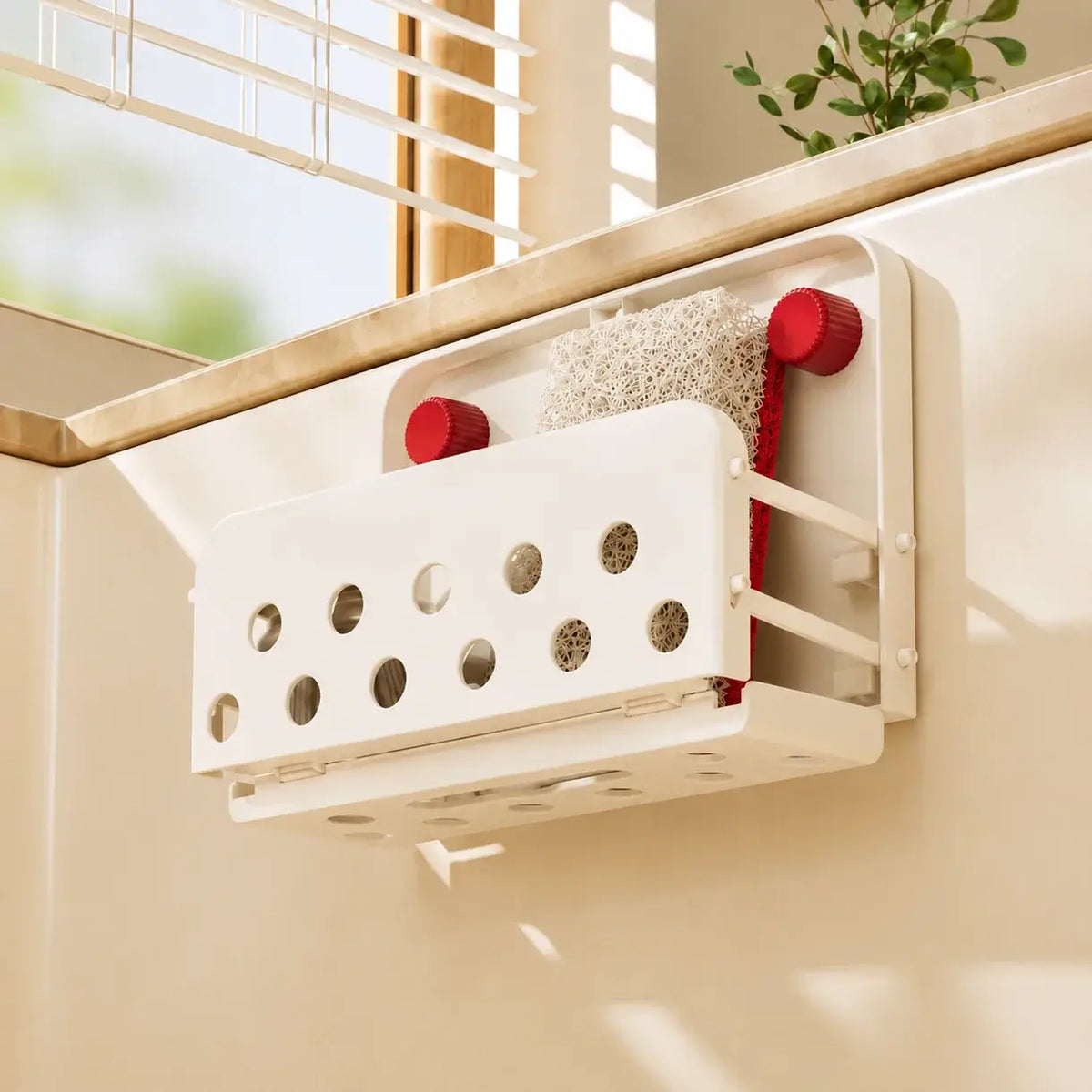 Off-white FoldAway Sink Caddy draining over the sink