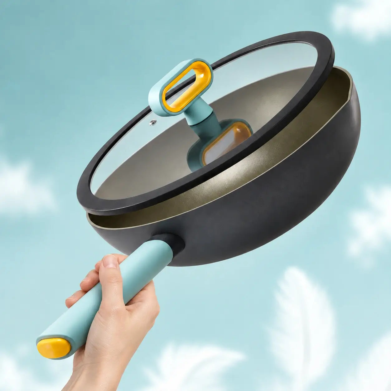 Hand lifting the lightweight pan with its glass lid