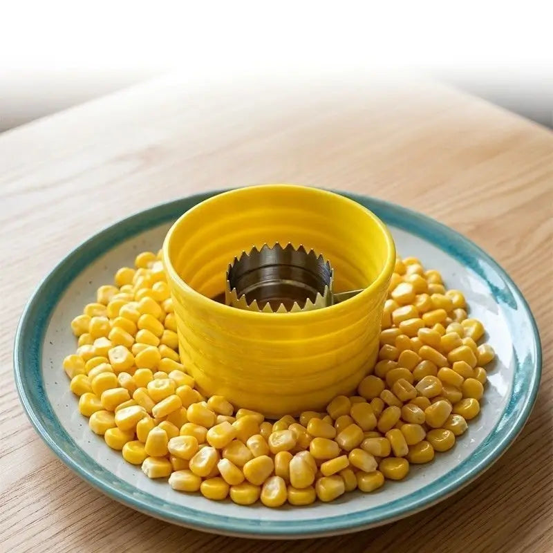 Freshly removed corn kernels surrounding the yellow tool